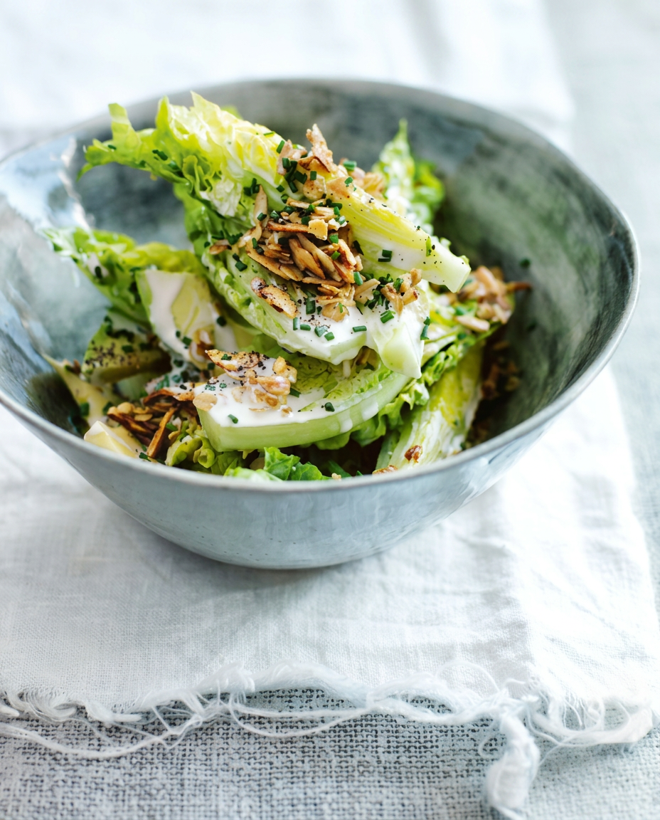 Baby gem lettuce with chives and toasted almonds in a blue-grey glazed bowl